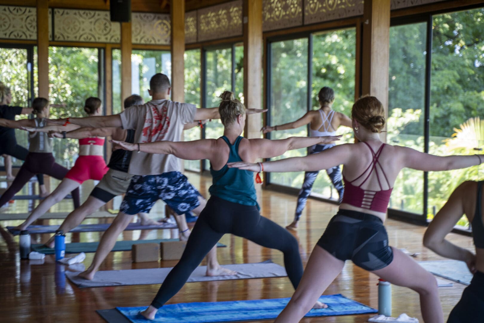 People practicing yoga in a studio.